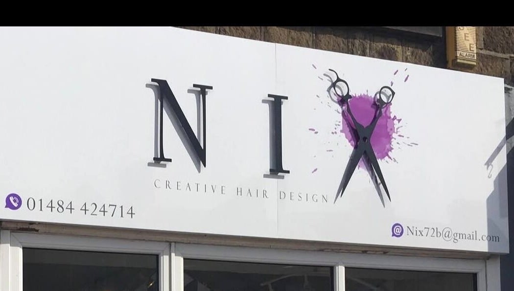 Nix Creative Hair Design signage at Huddersfield, England, GB showcasing scissors icon and contact details.
