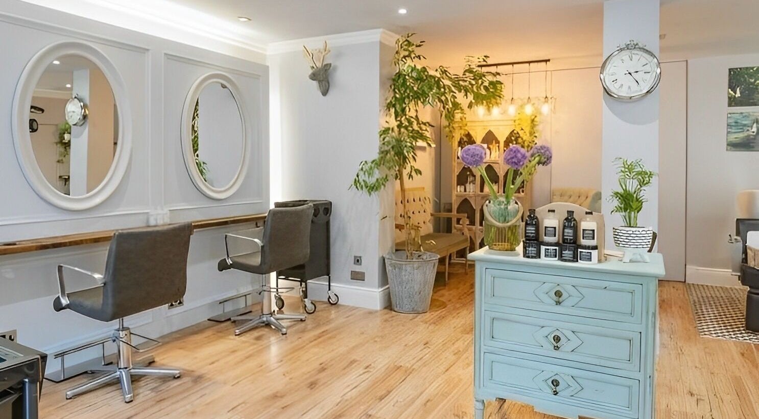 Stylish interior of Smoke & Mirrors Hair Salon, Aberdeen, Scotland with elegant decor and comfortable seating.