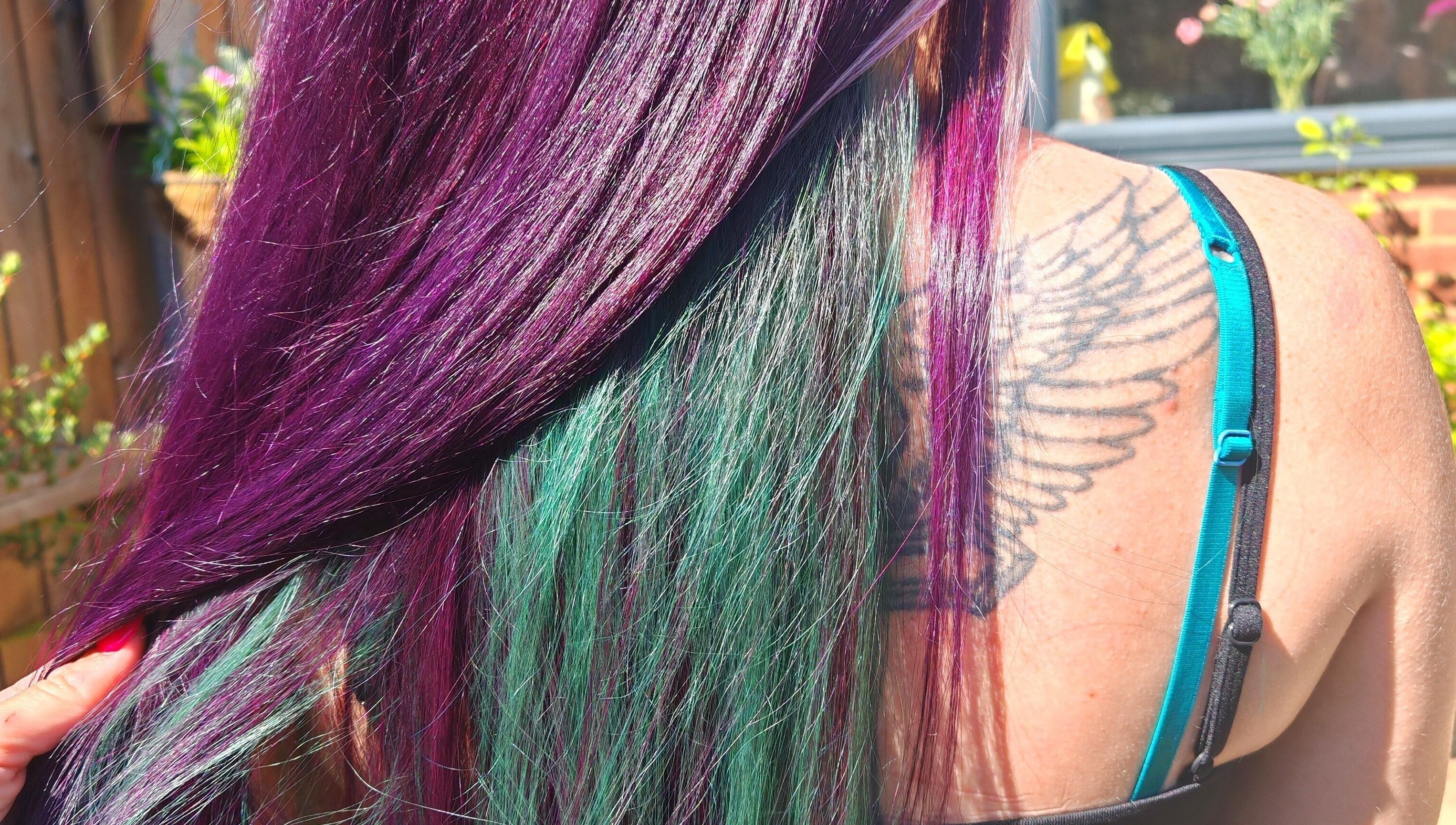 Vibrant purple and green hair styled at Dannielle's Cutting Edge, Littlestone, England, GB.