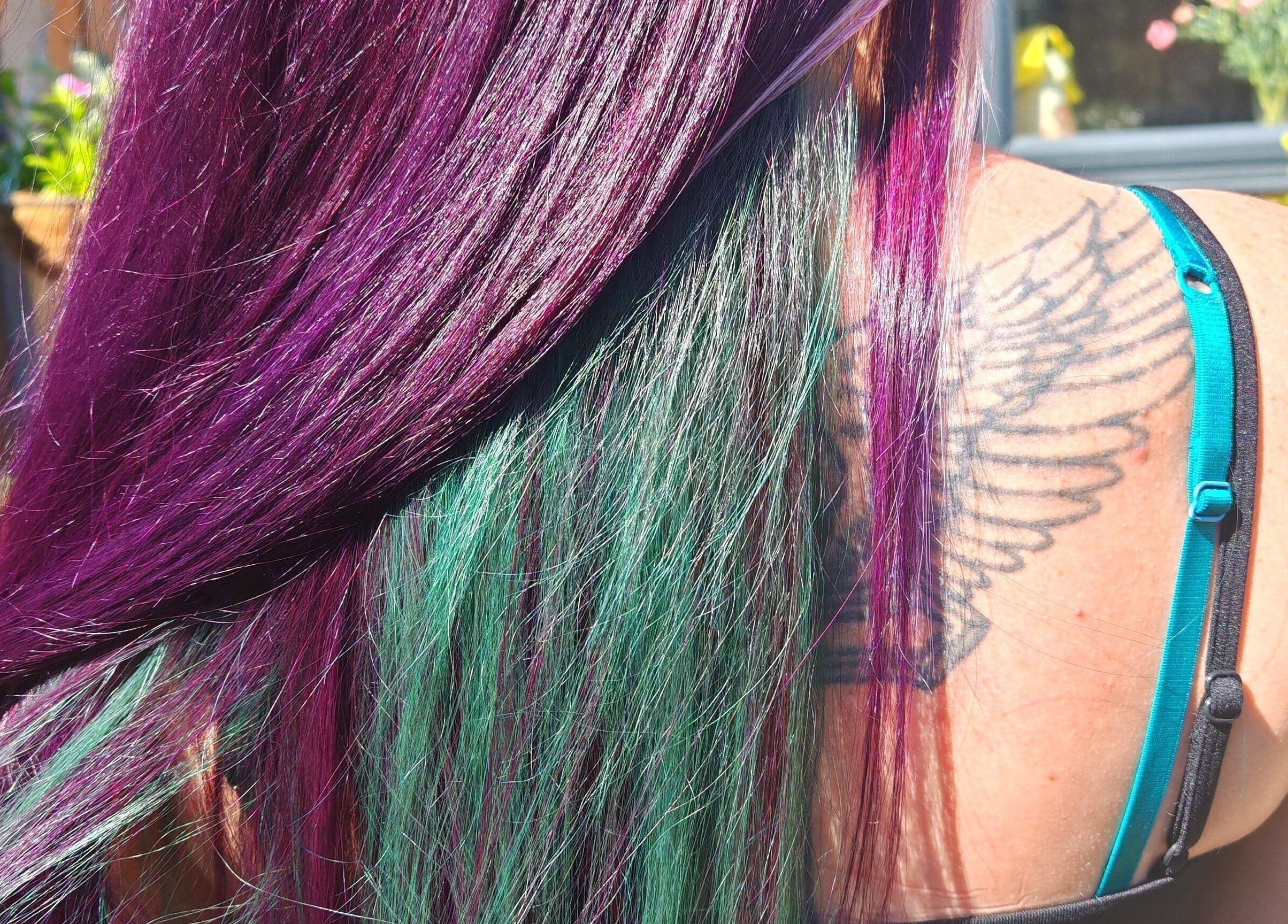 Vibrant purple and green hair styled at Dannielle's Cutting Edge, Littlestone, England, GB.