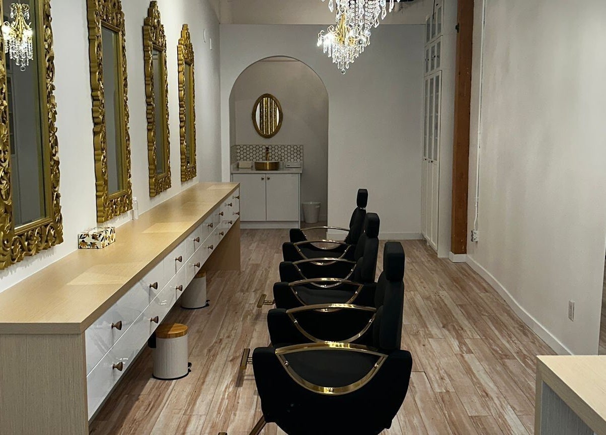 Luxurious interior of Panache Brow House (Gastown) in Vancouver, British Columbia, CA with ornate mirrors and chandeliers.