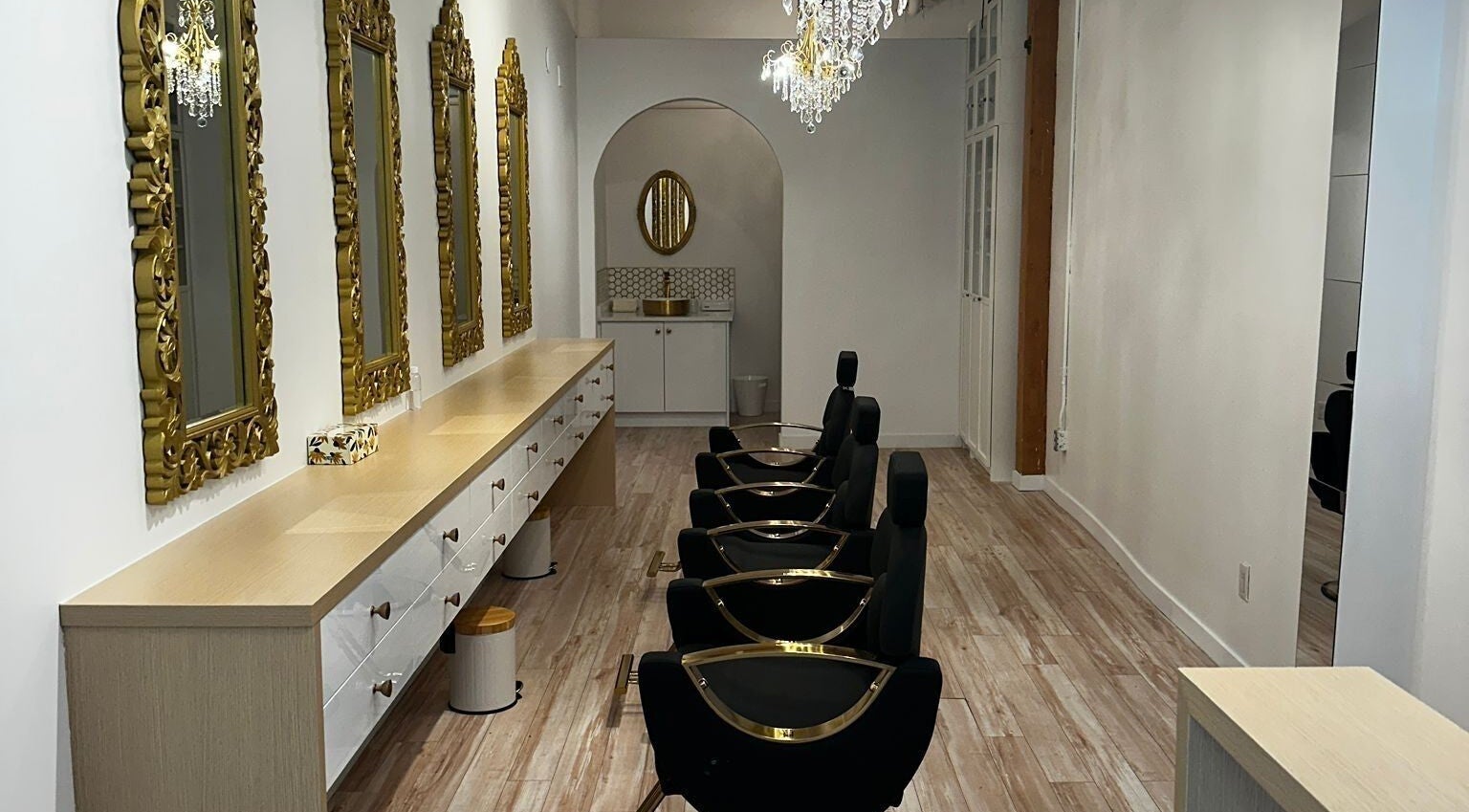 Luxurious interior of Panache Brow House (Gastown) in Vancouver, British Columbia, CA with ornate mirrors and chandeliers.