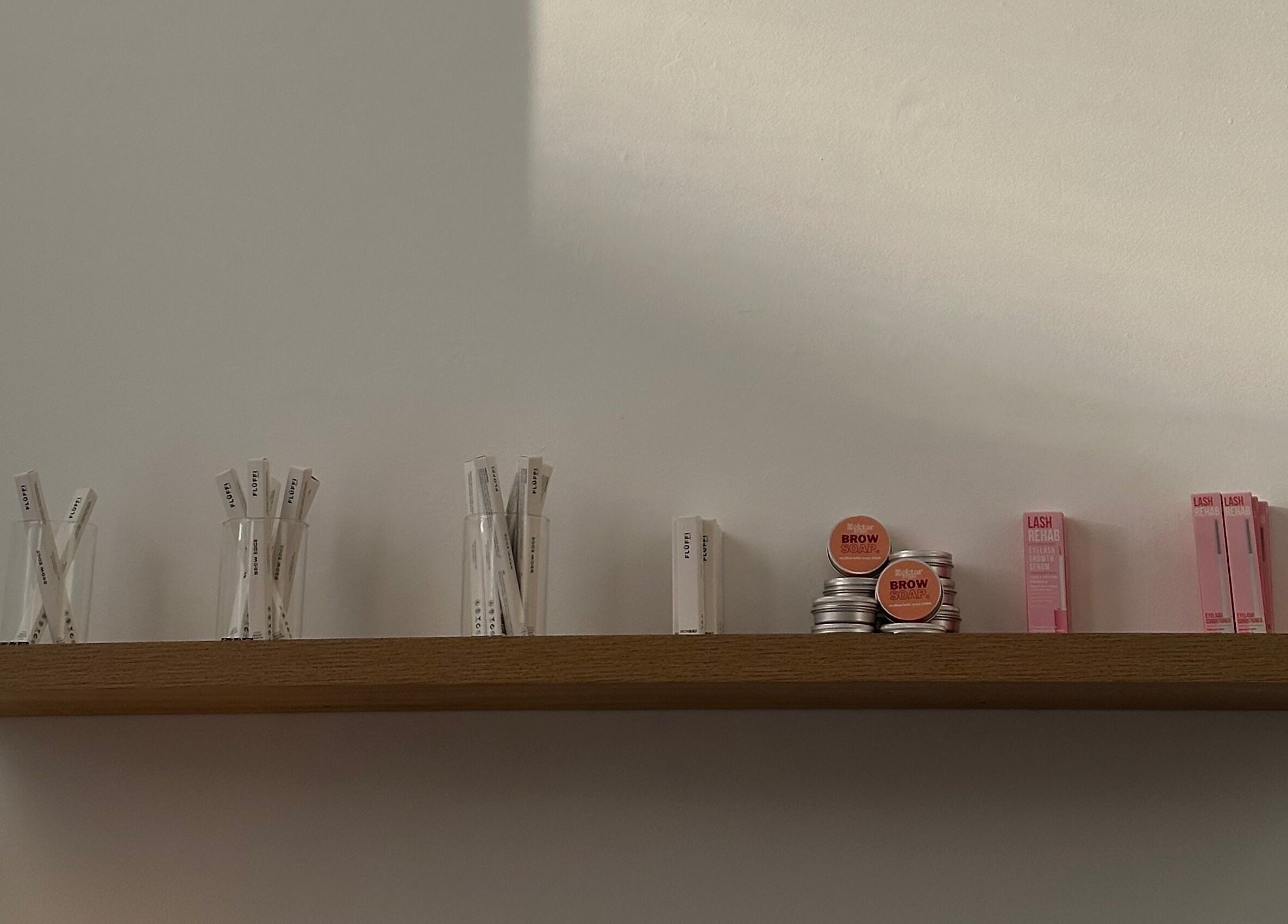 Beauty products displayed on a wooden shelf at Néktar Studio, Melbourne, Victoria, AU.