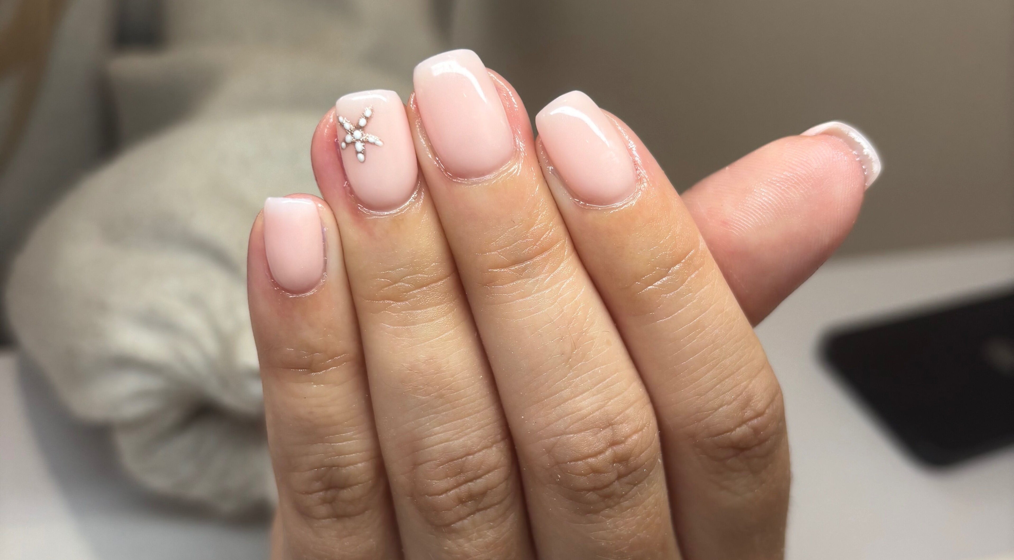 Elegant nude manicured nails with rhinestone accents at Serenity Beauty, Ayr, Scotland, GB.