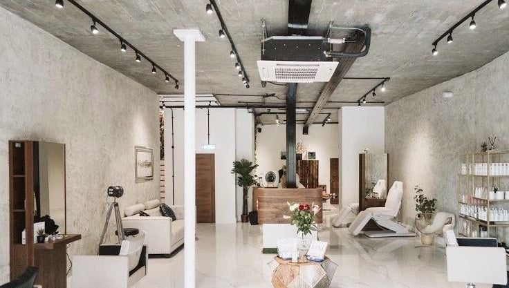 Modern beauty salon interior of Laura Louise in London, England, GB with stylish decor and treatment chairs.