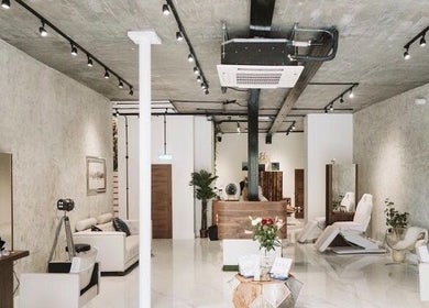 Modern beauty salon interior of Laura Louise in London, England, GB with stylish decor and treatment chairs.