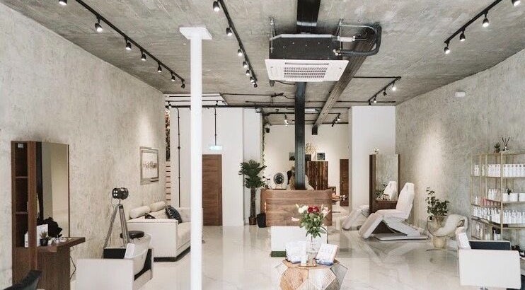 Modern beauty salon interior of Laura Louise in London, England, GB with stylish decor and treatment chairs.