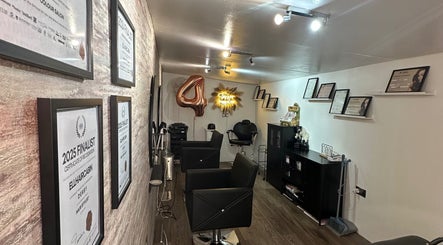 Elegant salon interior at ellhaircabin, Derby, England, GB, showcasing awards and trendy decor.