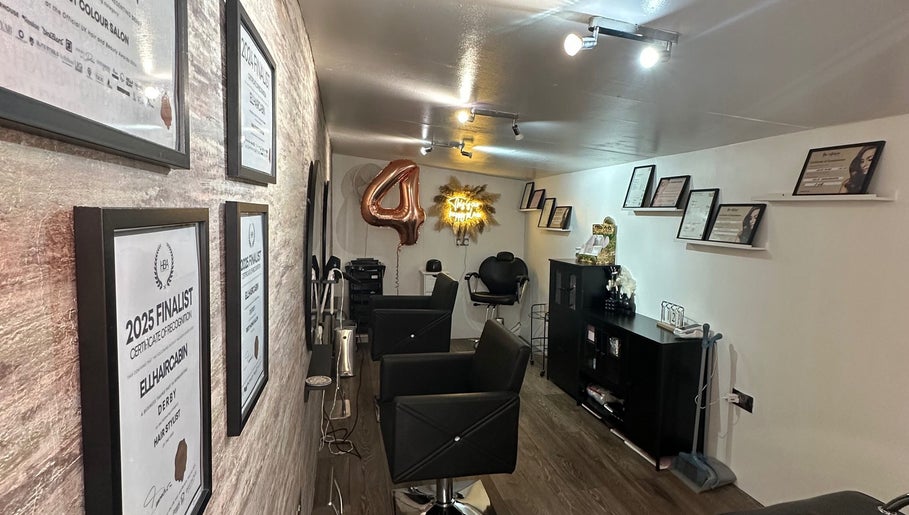 Ellhaircabin interior in Derby, England, showcasing awards and styling chairs in a modern salon setting.