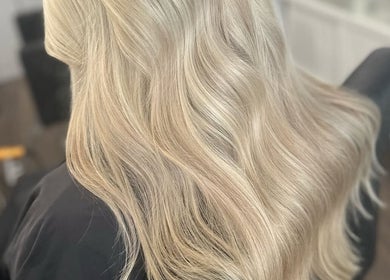 Blonde wavy hair styled at Ellhaircabin, Derby, England, GB, showcasing expert salon techniques.