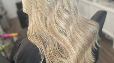 Blonde wavy hair styled at Ellhaircabin, Derby, England, GB, showcasing expert salon techniques.