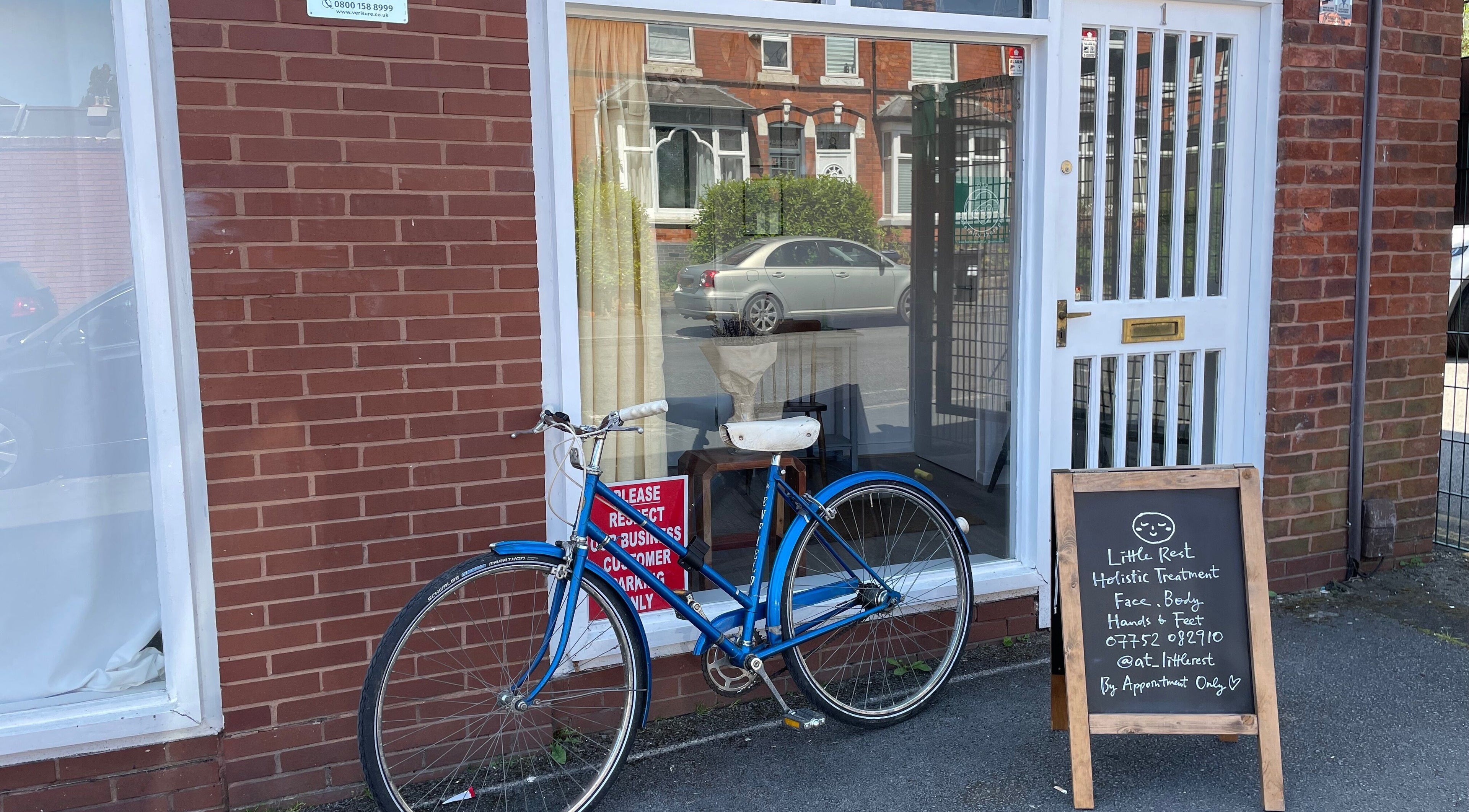 Front of Little Rest Skin Treatment Room, Birmingham, England, GB, with vintage bike and signage.