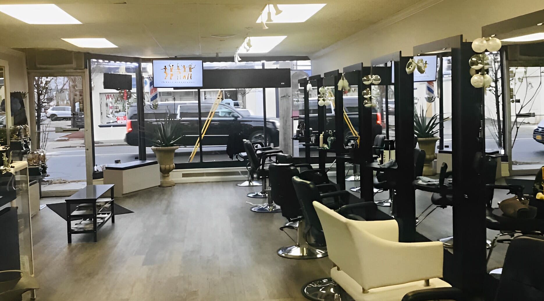 Modern interior of Eloisa’s Unisex Beauty Salón in Patchogue, New York, US, featuring sleek styling stations.