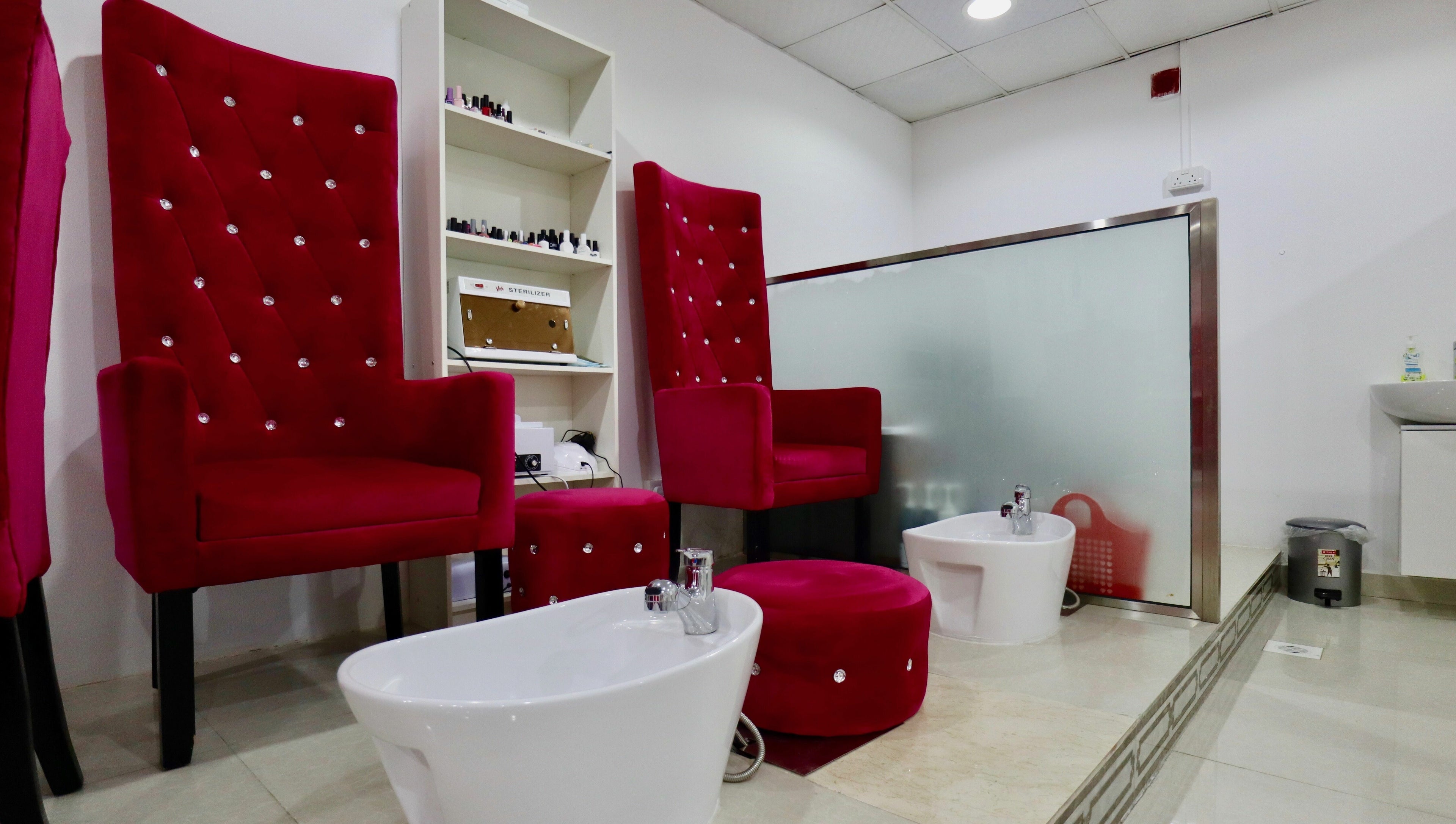 Red velvet pedicure chairs at Anjelika's Beauty Salon, Dubai, AE. Perfect setting for relaxation and luxury treatments.