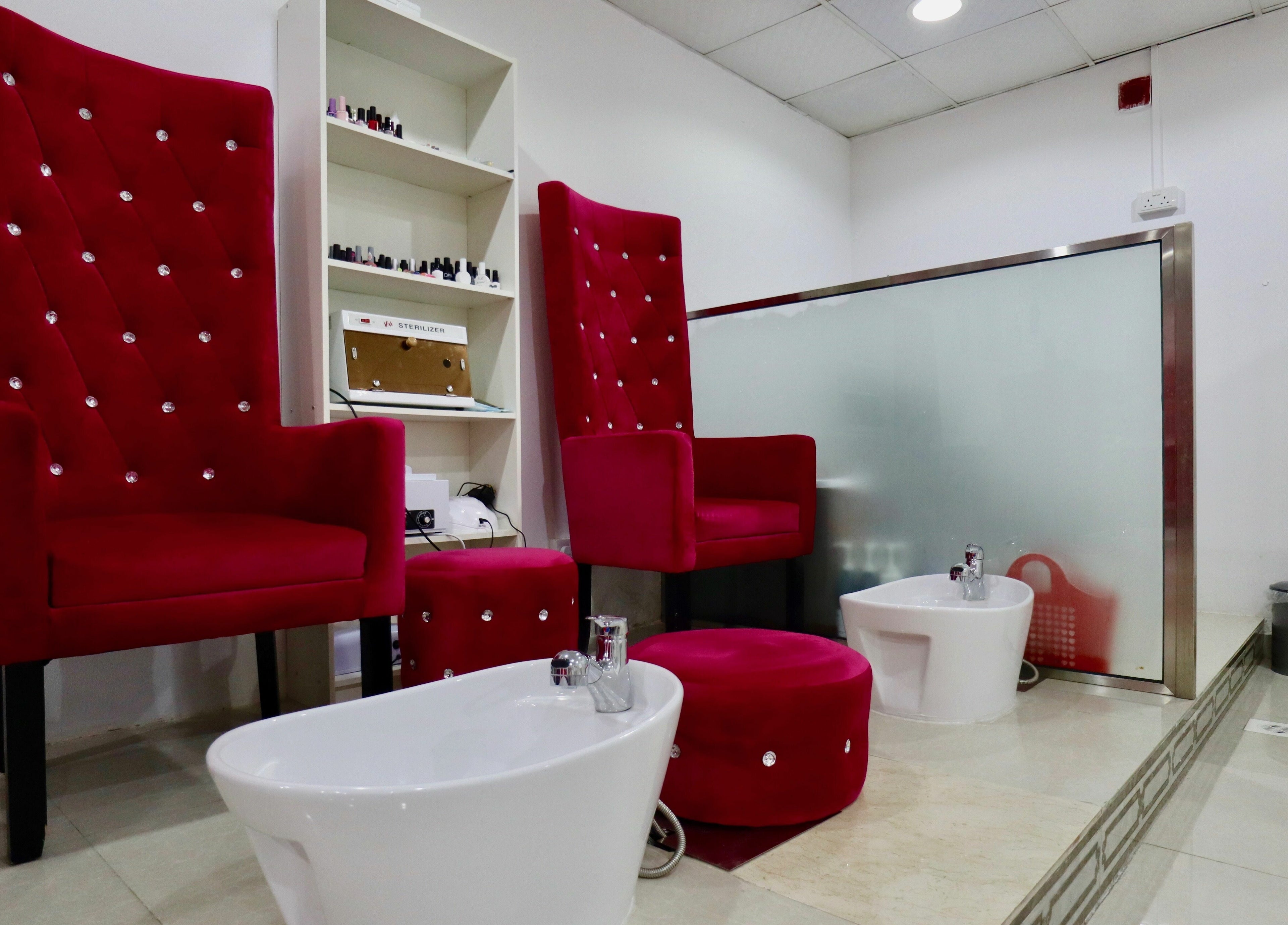 Red velvet pedicure chairs at Anjelika's Beauty Salon, Dubai, AE. Perfect setting for relaxation and luxury treatments.