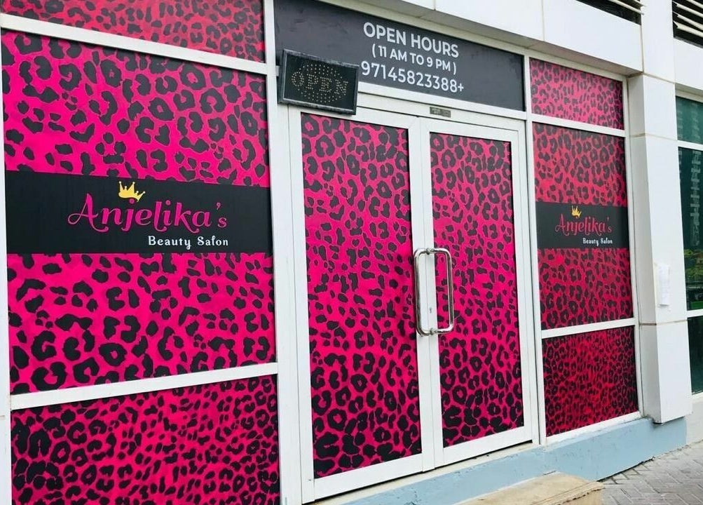 Front entrance of Anjelika's Beauty Salon in Dubai, AE, with vibrant pink leopard print decor.
