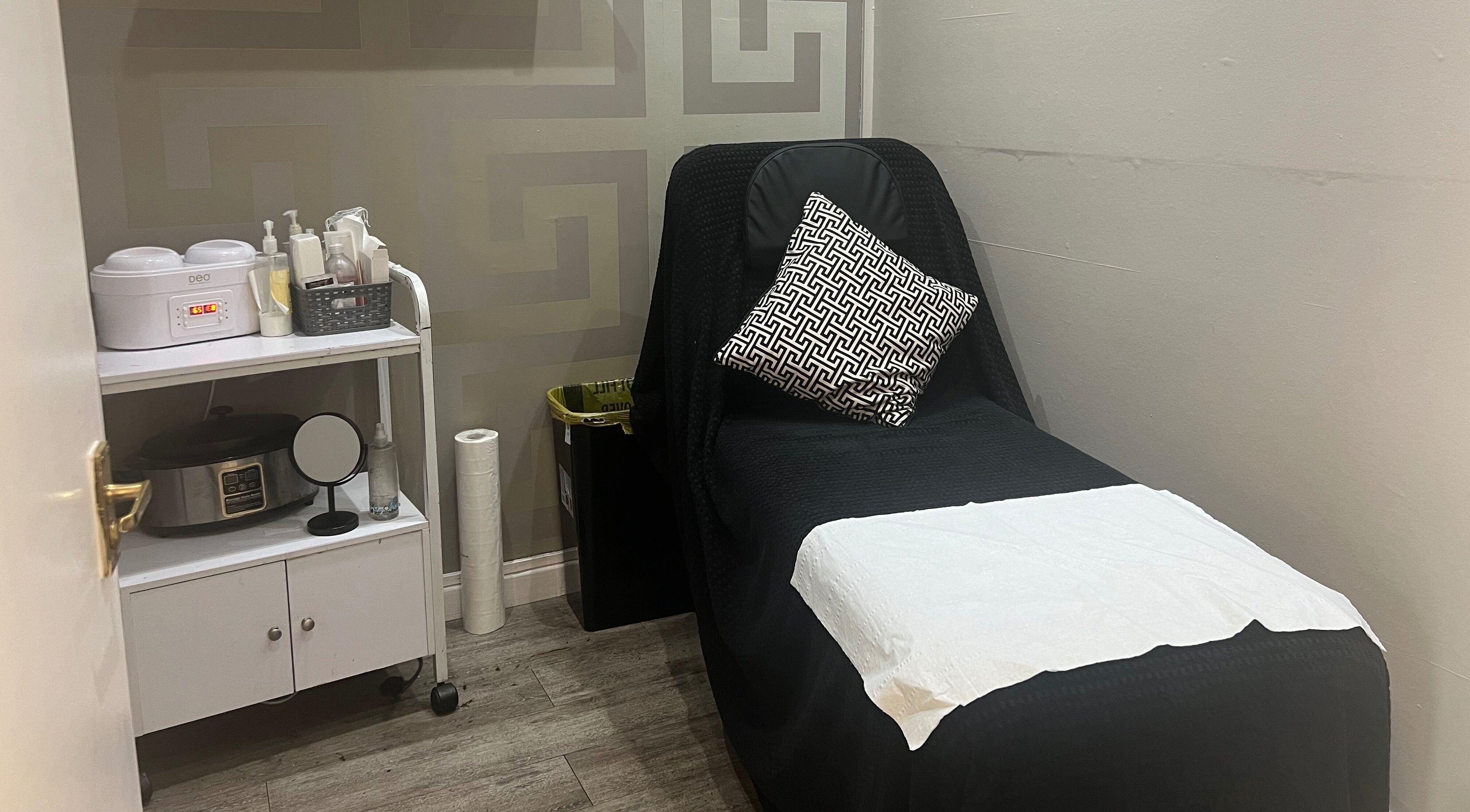 Treatment room at Foxy Beauty Salon - Llandaff, Cardiff, Wales, GB with a cozy chair and beauty essentials.