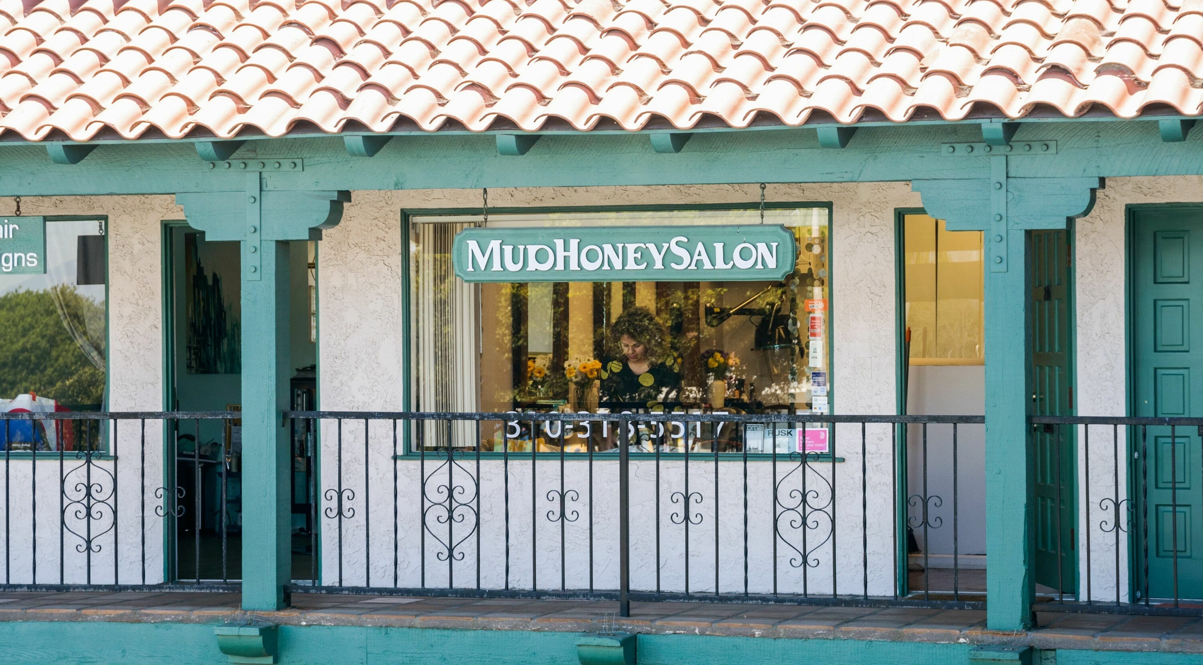 Exterior of Mud Honey Salon in Manhattan Beach, California, showcasing its welcoming and vibrant entrance.