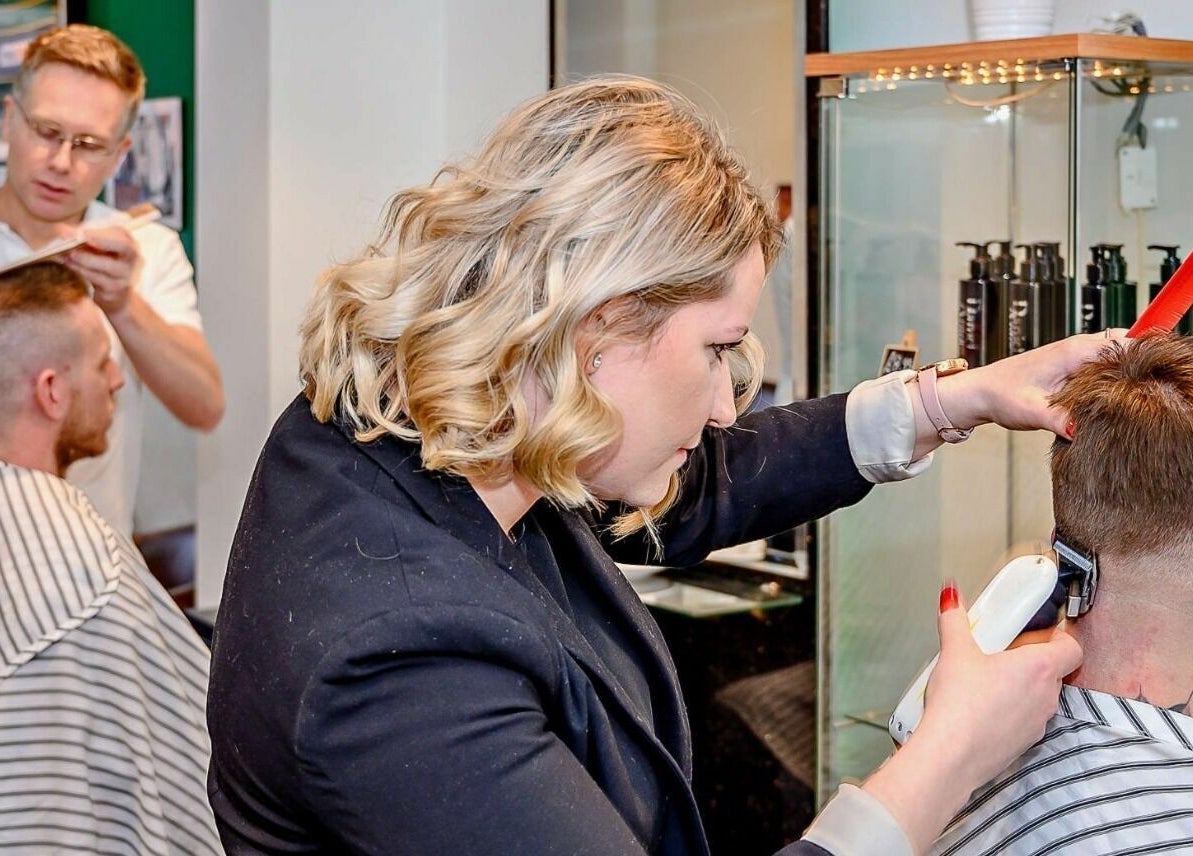 Professional barbers at work in Daniel Antony, Northampton, England, GB delivering precise haircuts.