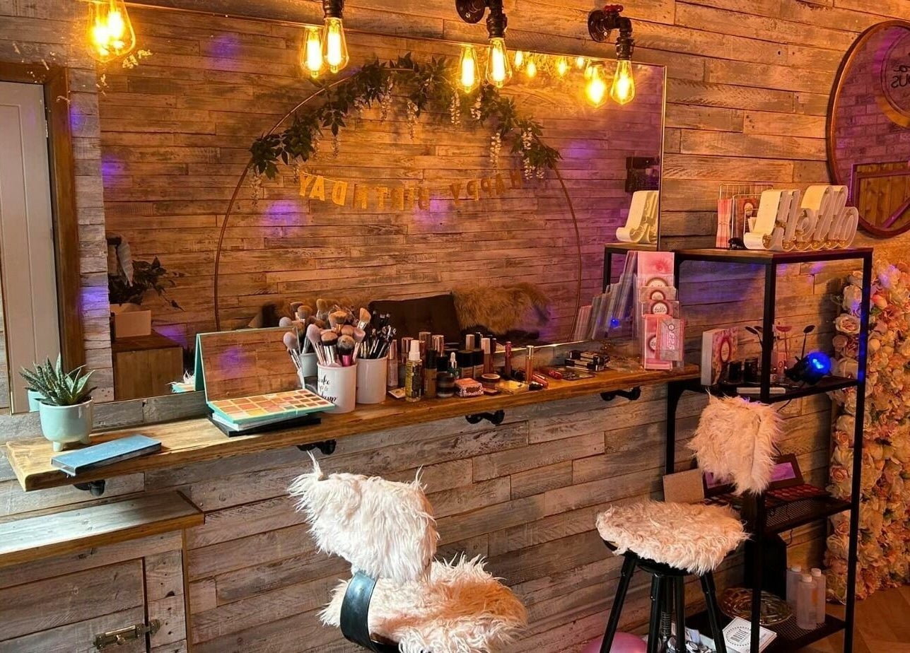 Cozy makeup area with fluffy chairs at Lash & Co, Fleetwood, England, GB. Warm lighting and decorative touches.