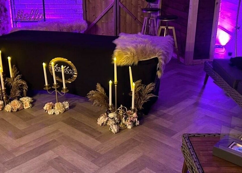 Elegant spa room at Lash & Co, Fleetwood, England, GB with candles and cozy decor creating a relaxing atmosphere.