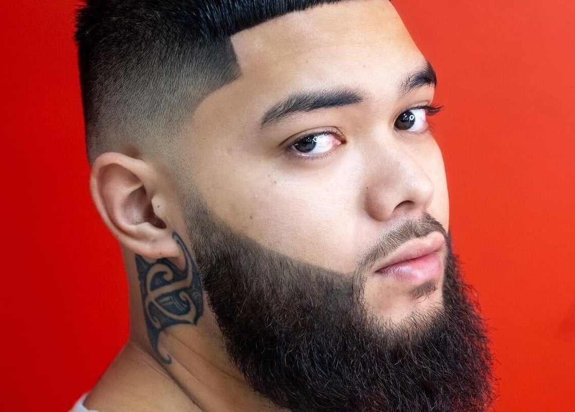 Sophisticated beard styling at MVP Cutz PTY LTD in Melbourne, Victoria, AU on a vibrant red backdrop.