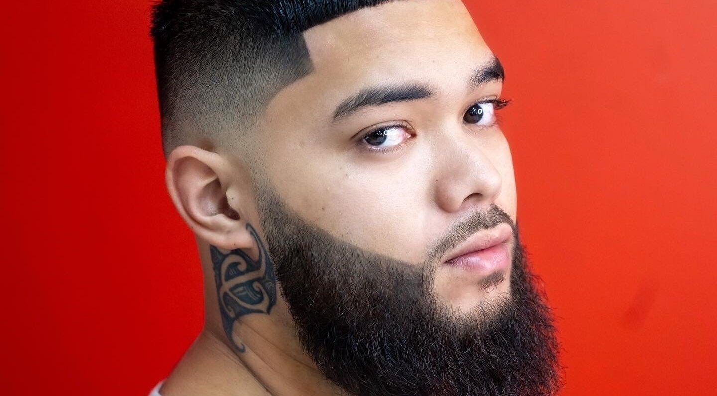 Sophisticated beard styling at MVP Cutz PTY LTD in Melbourne, Victoria, AU on a vibrant red backdrop.