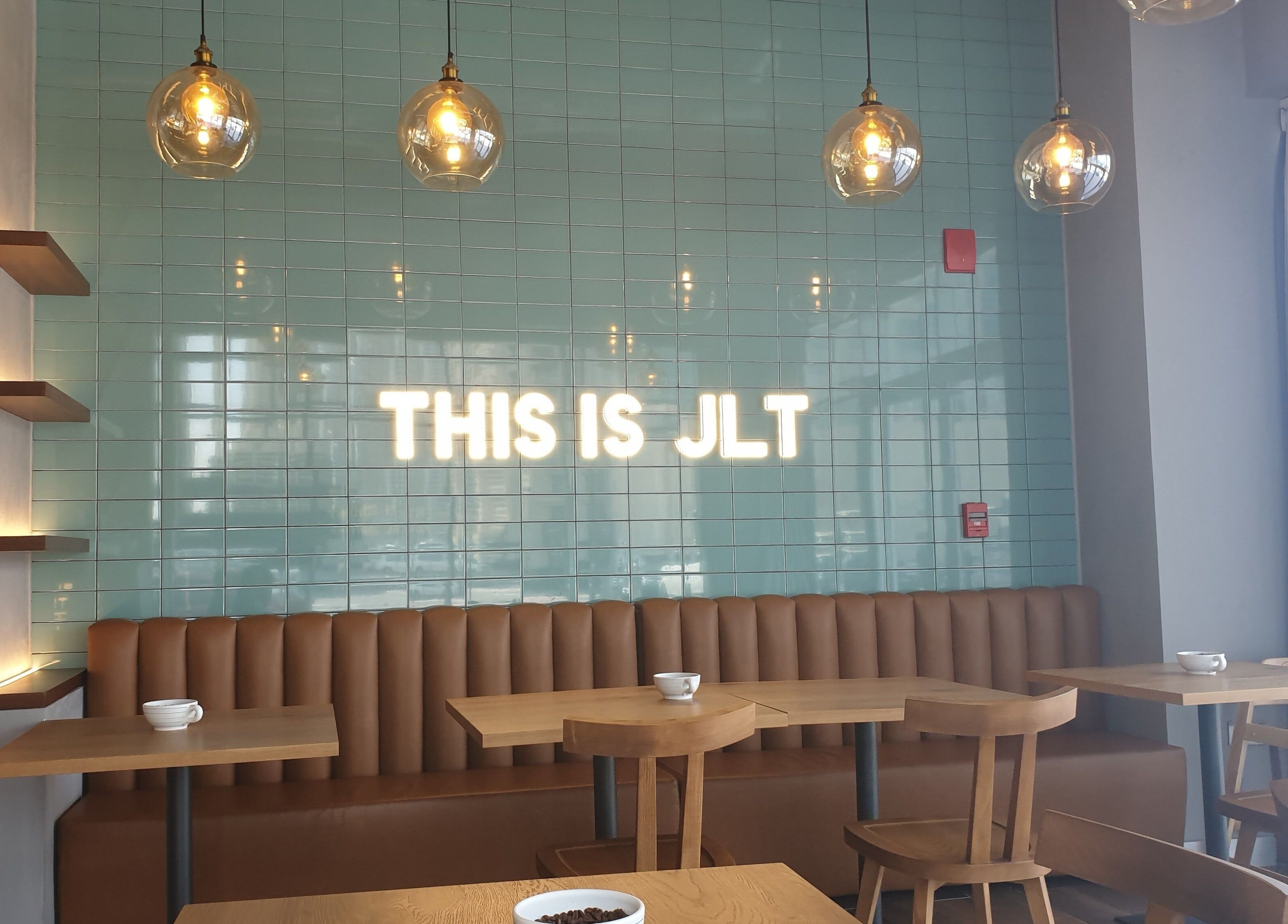 Cozy seating area at The Clippers, Cluster Q, JLT, Dubai, Dubai, AE, featuring 'THIS IS JLT' neon sign.