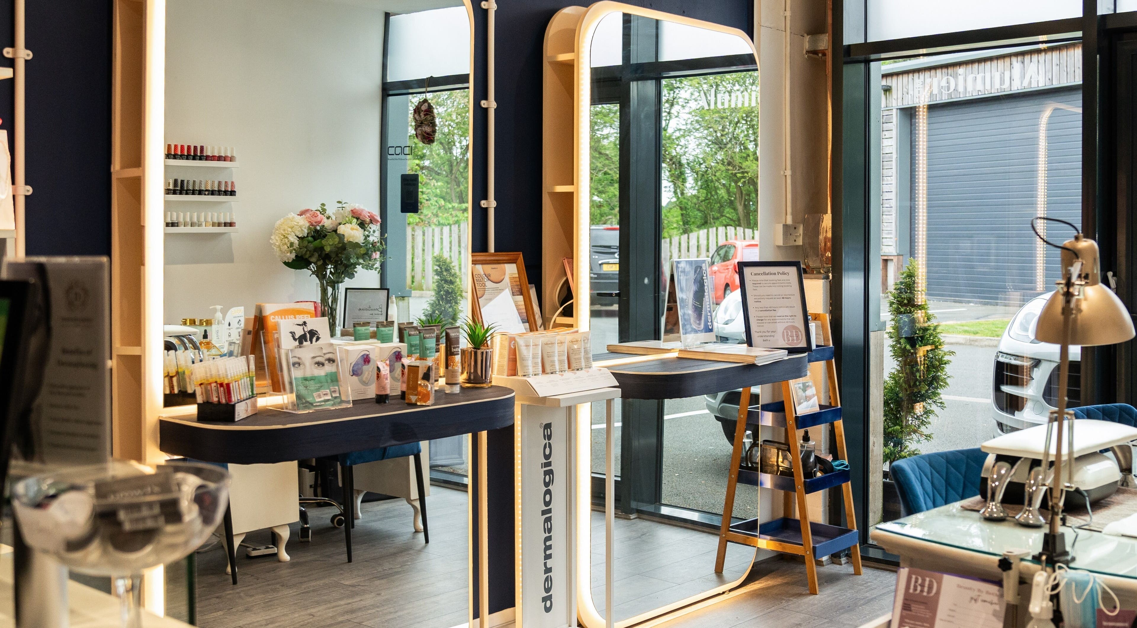 Inside Be Stunning Too, Whalley, England: elegant beauty products displayed under warm lighting.