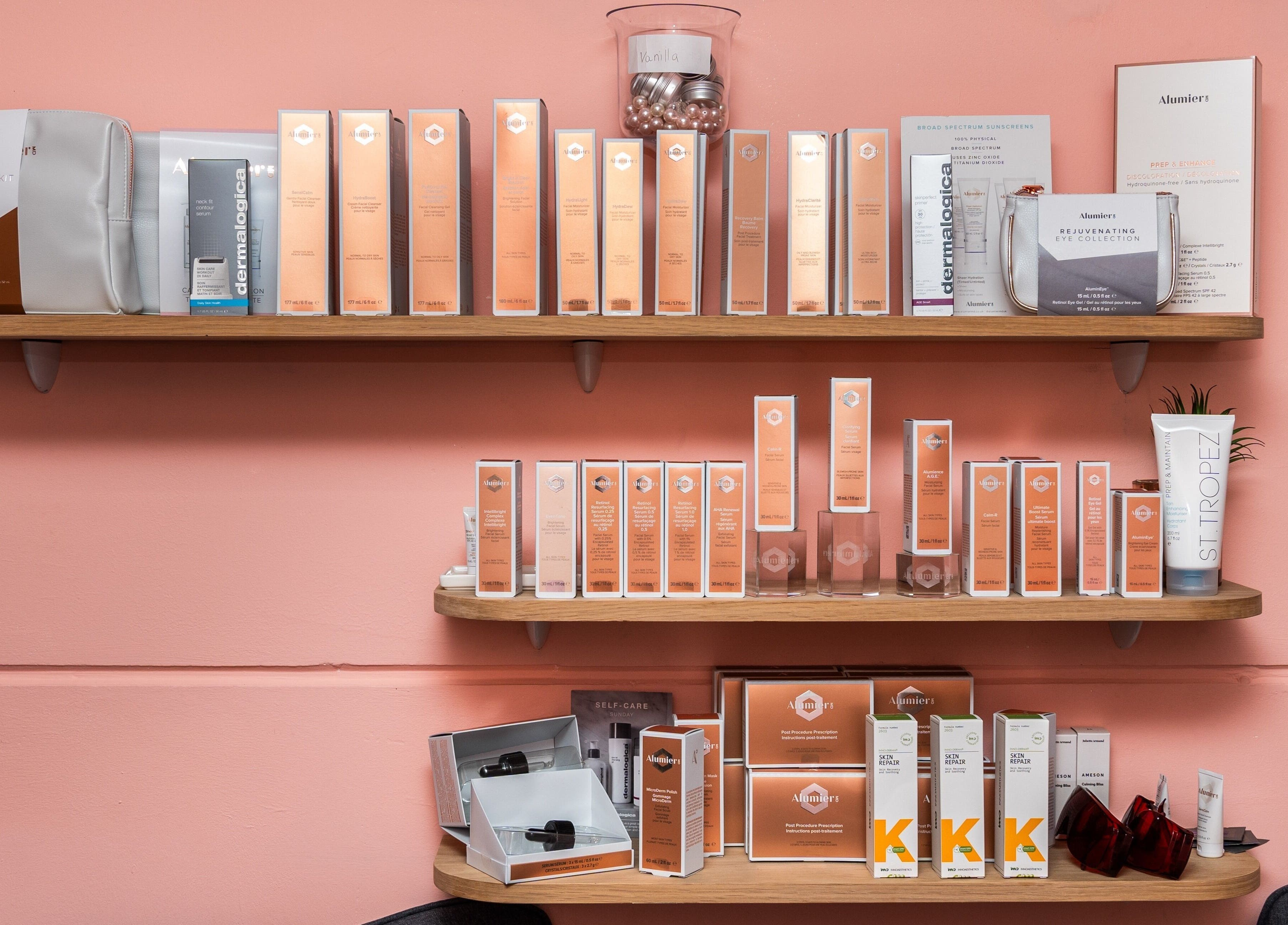Skincare products at Be Stunning Too, Whalley, England, GB displayed on wooden shelves in a beauty setting.