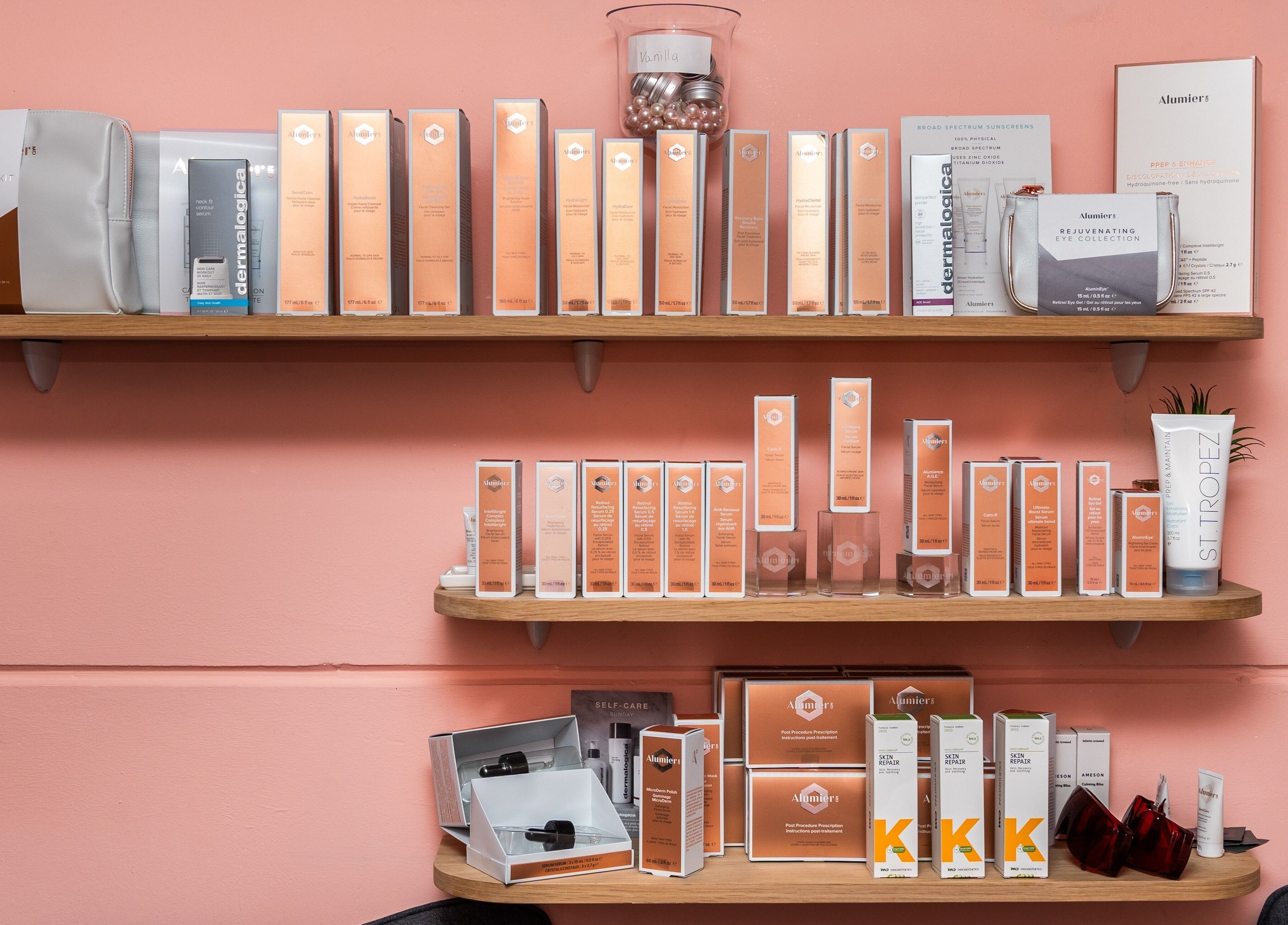 Skincare products at Be Stunning Too, Whalley, England, GB displayed on wooden shelves in a beauty setting.