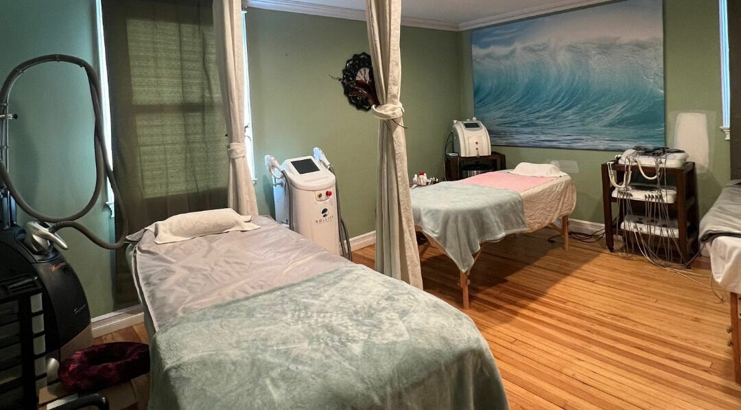 Peaceful treatment room at Eloisa Beauty Center & Spa, Patchogue, New York, US, featuring cozy massage beds.
