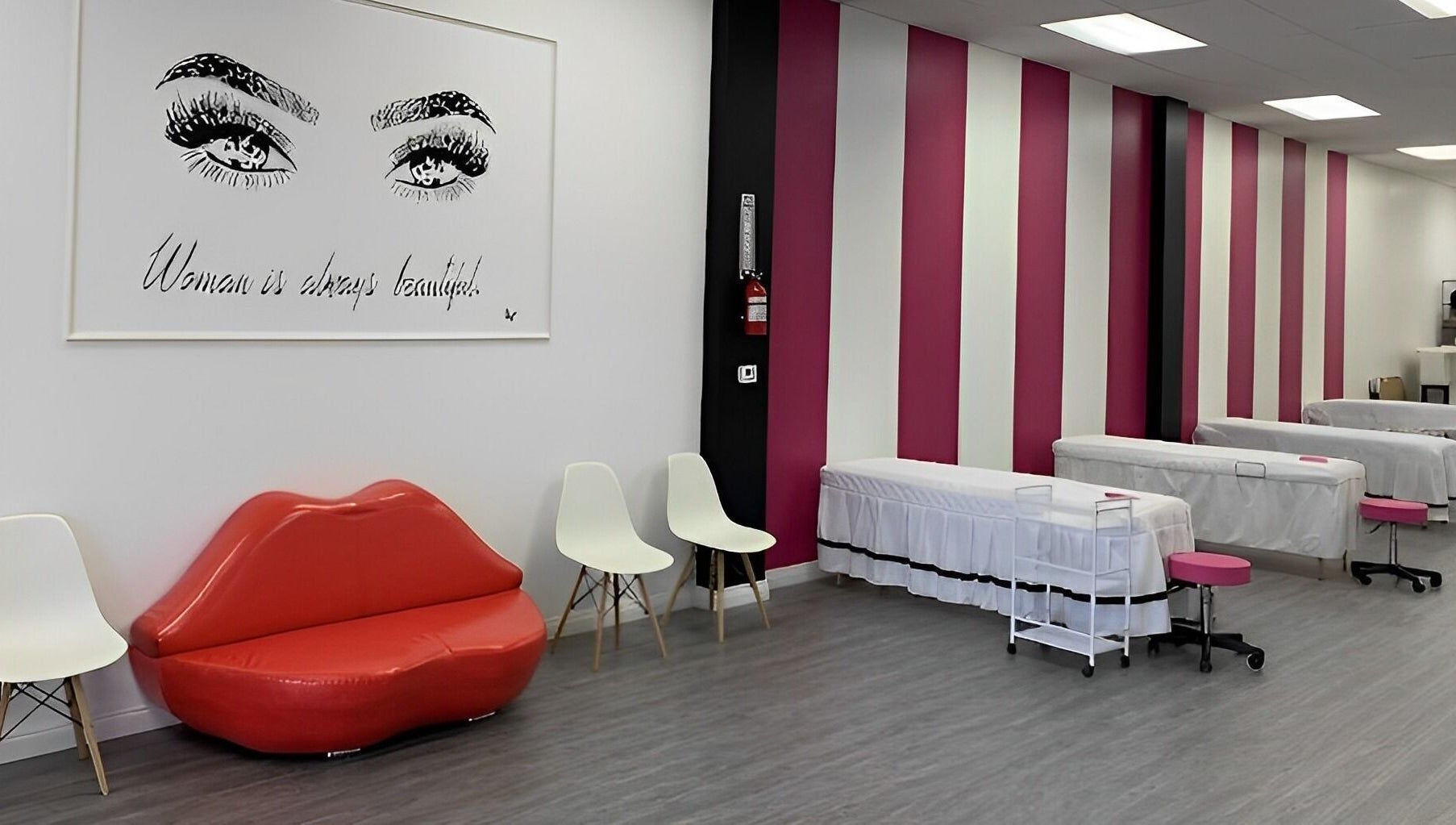 Elegant interior of Super Q Lash Beauty, Upland, California, US, with pink striped walls and stylish decor.