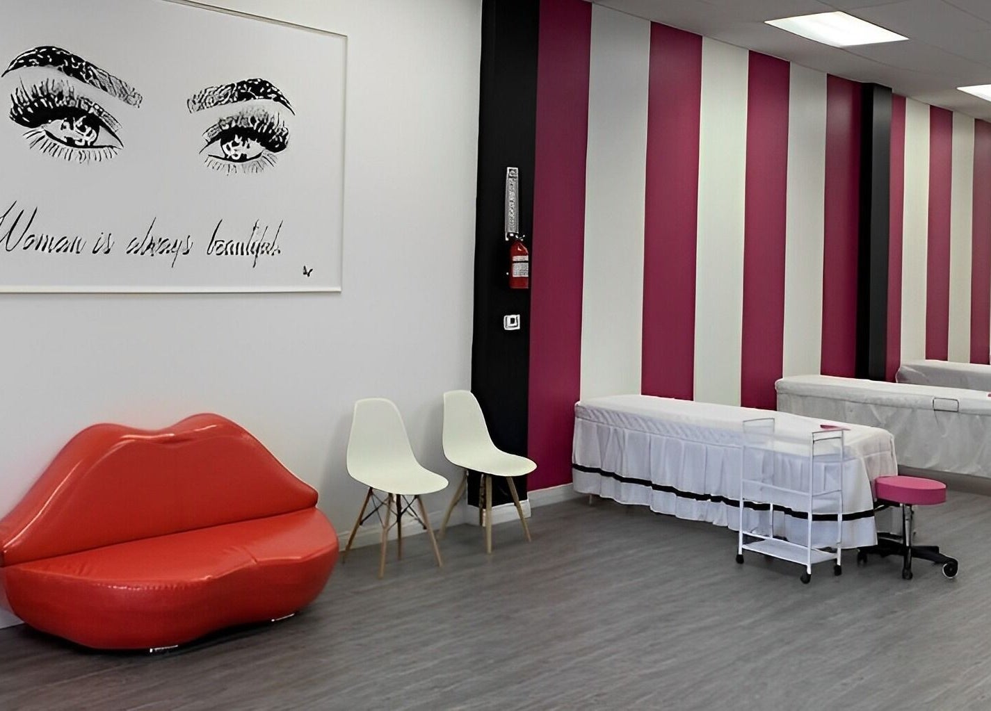 Elegant interior of Super Q Lash Beauty, Upland, California, US, with pink striped walls and stylish decor.