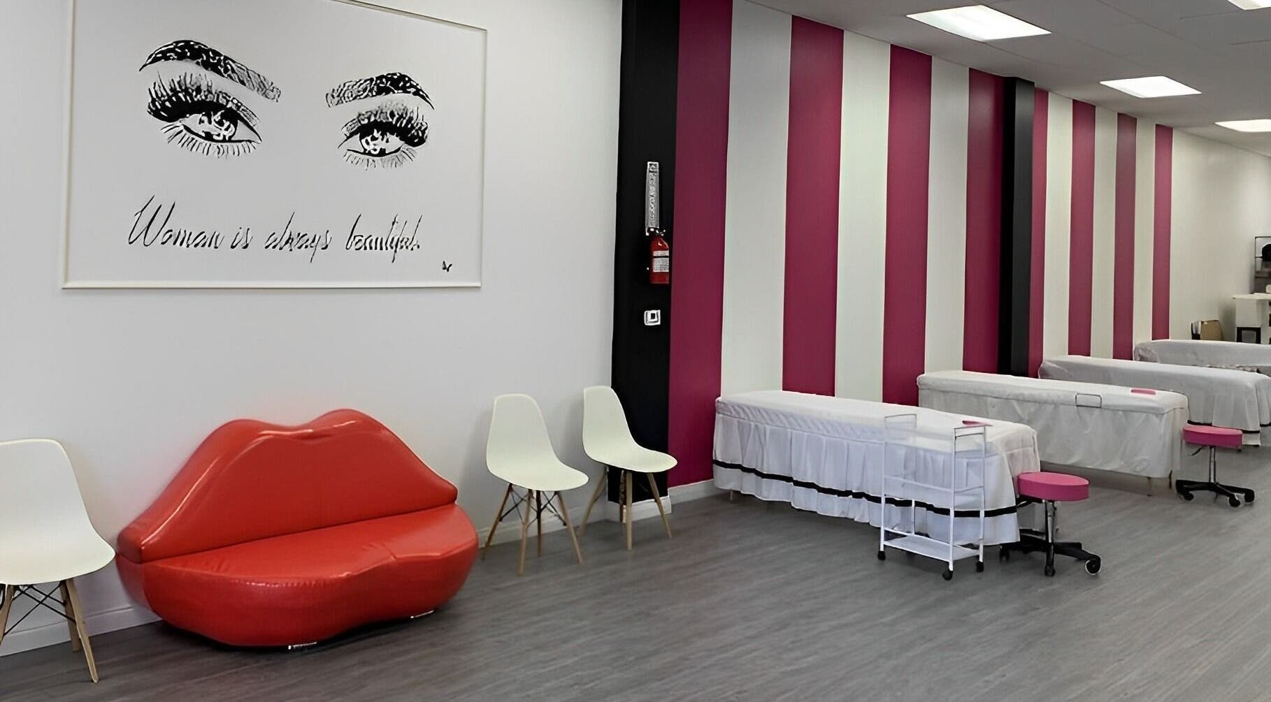 Elegant interior of Super Q Lash Beauty, Upland, California, US, with pink striped walls and stylish decor.