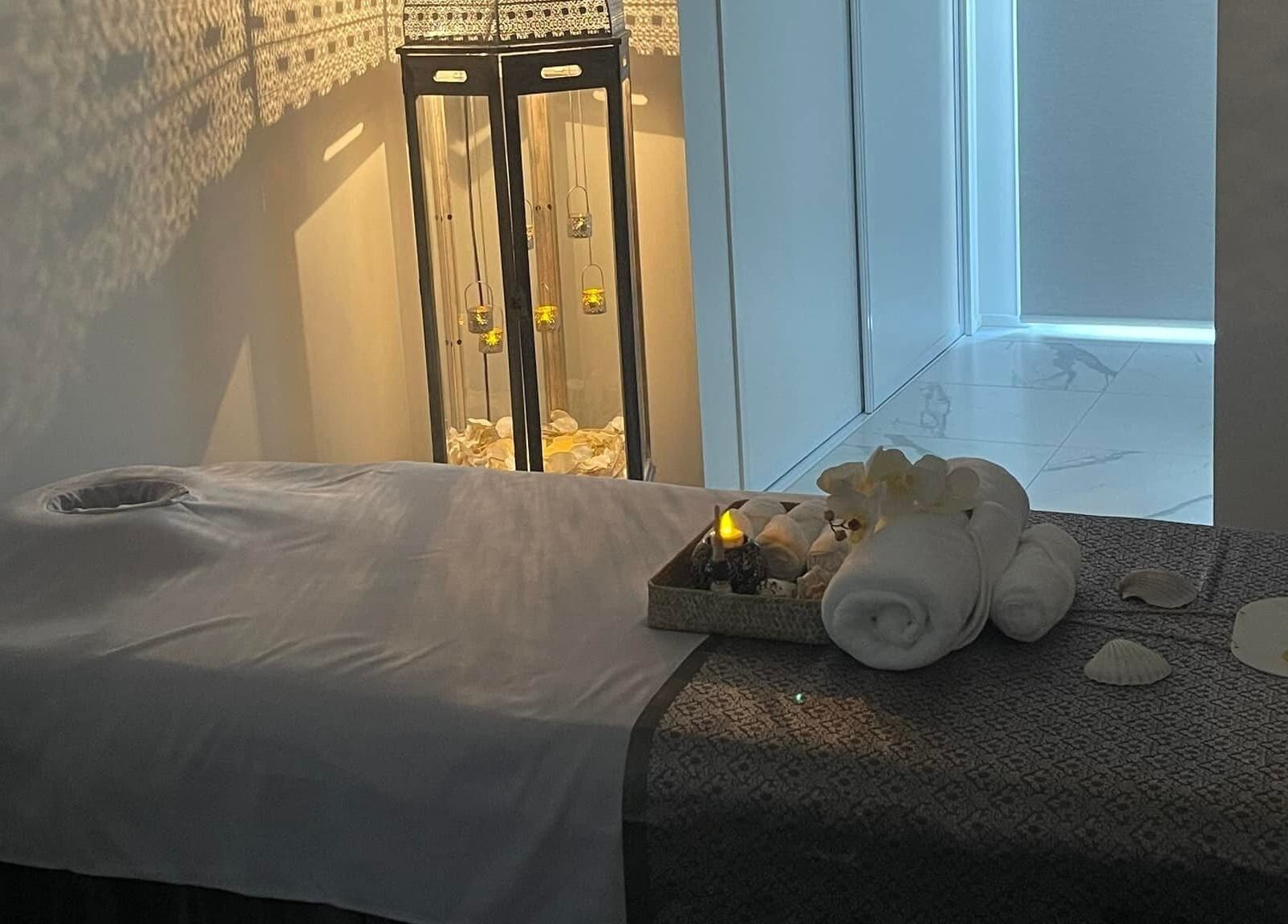 Tranquil massage room at Wai Thai Riccarton, Massage Clinic in Christchurch, NZ. Illuminated ambiance with towels and decor.