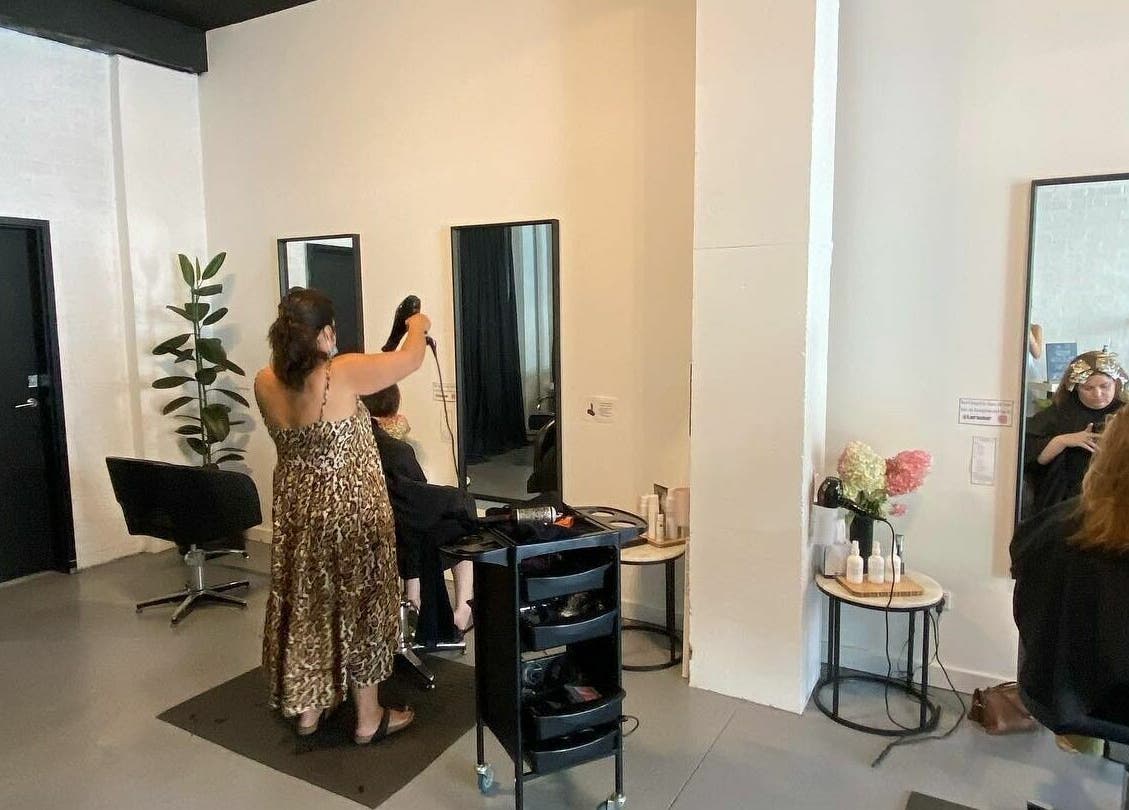 Stylist in action at Laura and Co Hairdressing, Rozelle, New South Wales, AU. A chic and modern salon atmosphere.