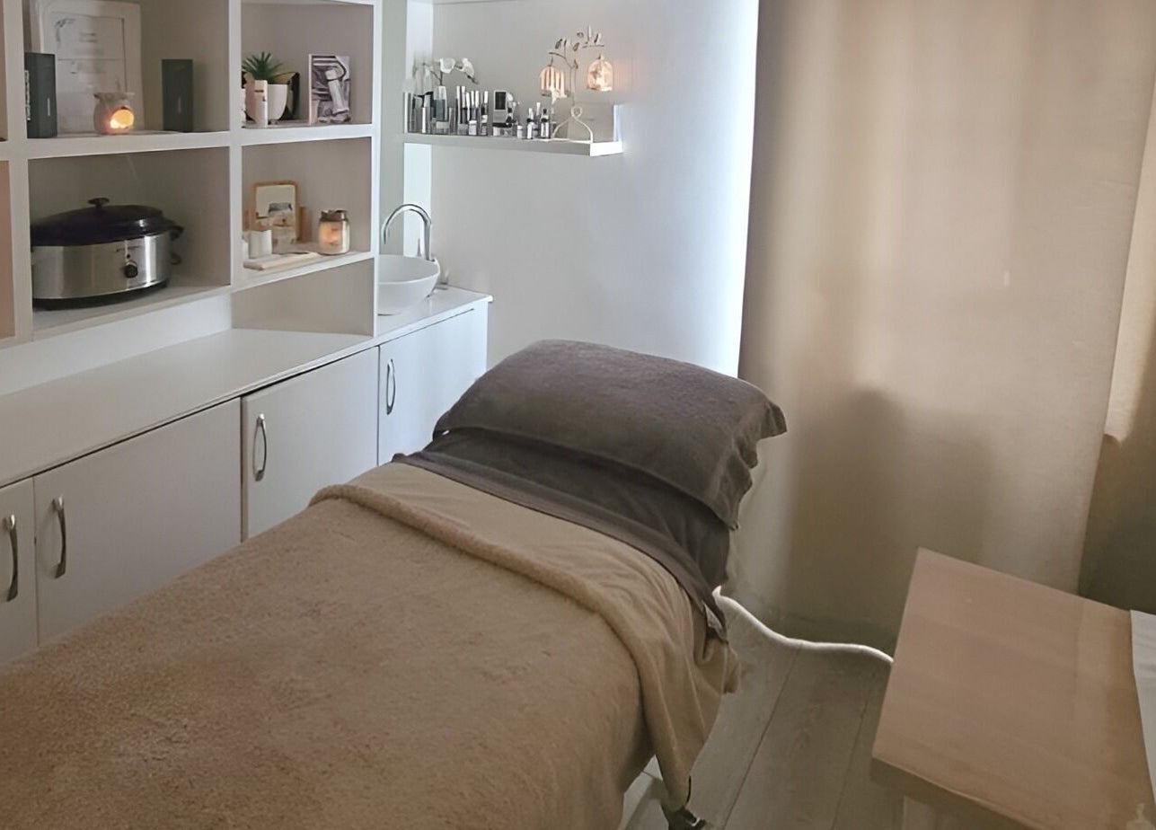 Chic therapy room in Preston, England, GB, featuring a massage bed and calming decor.