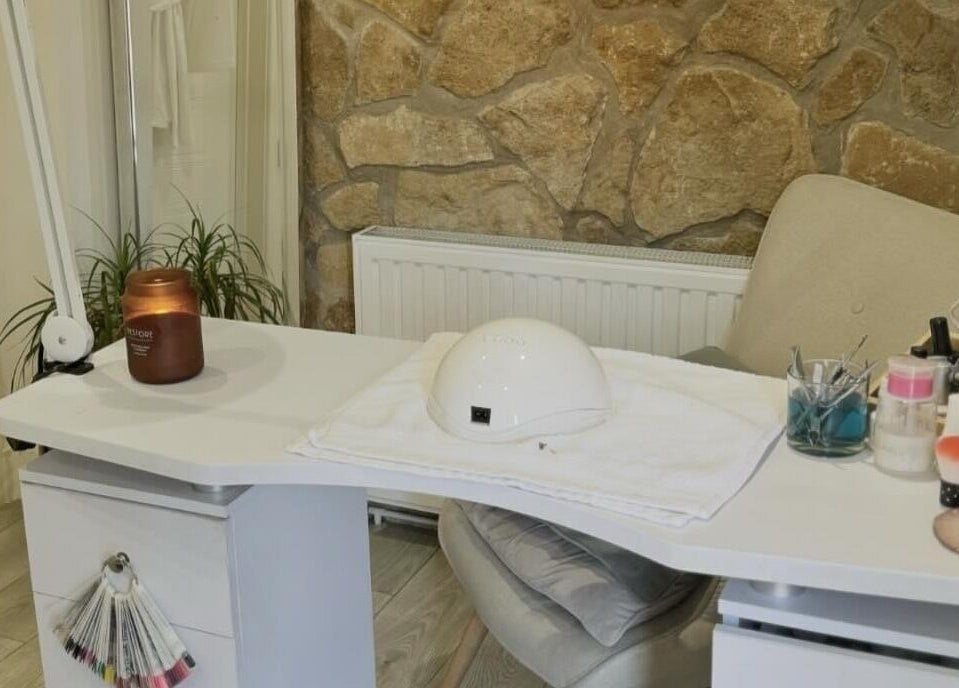 Cozy nail station at Chic in Preston, England with tools and decor on a white desk.