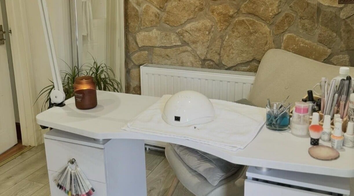 Cozy nail station at Chic in Preston, England with tools and decor on a white desk.