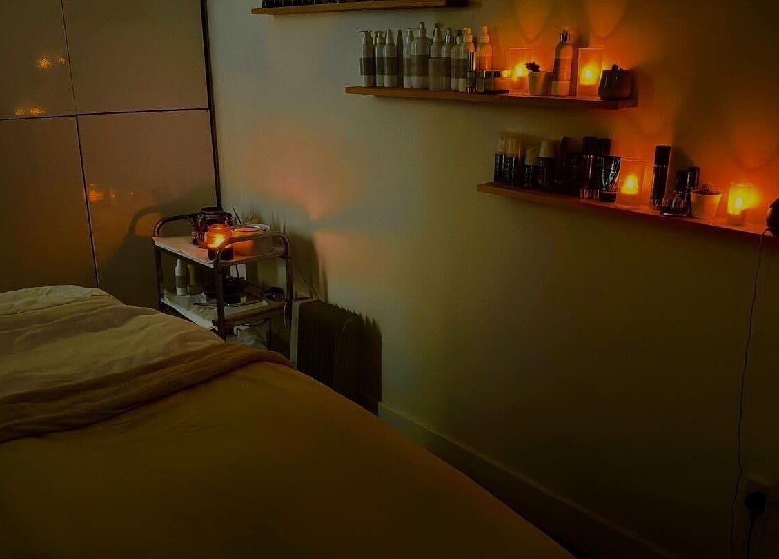 Warm, candlelit massage room at Chic, Preston, England, GB, creating a tranquil oasis for relaxation.