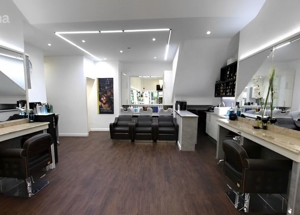 Modern interior of Design A Head Tunbridge Wells salon in Tunbridge Wells, England, featuring sleek chairs and mirrors.