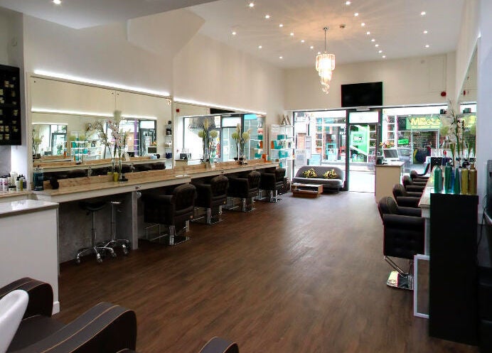 Elegant salon interior at Design A Head Tunbridge Wells, England, GB, showcasing modern styling stations.