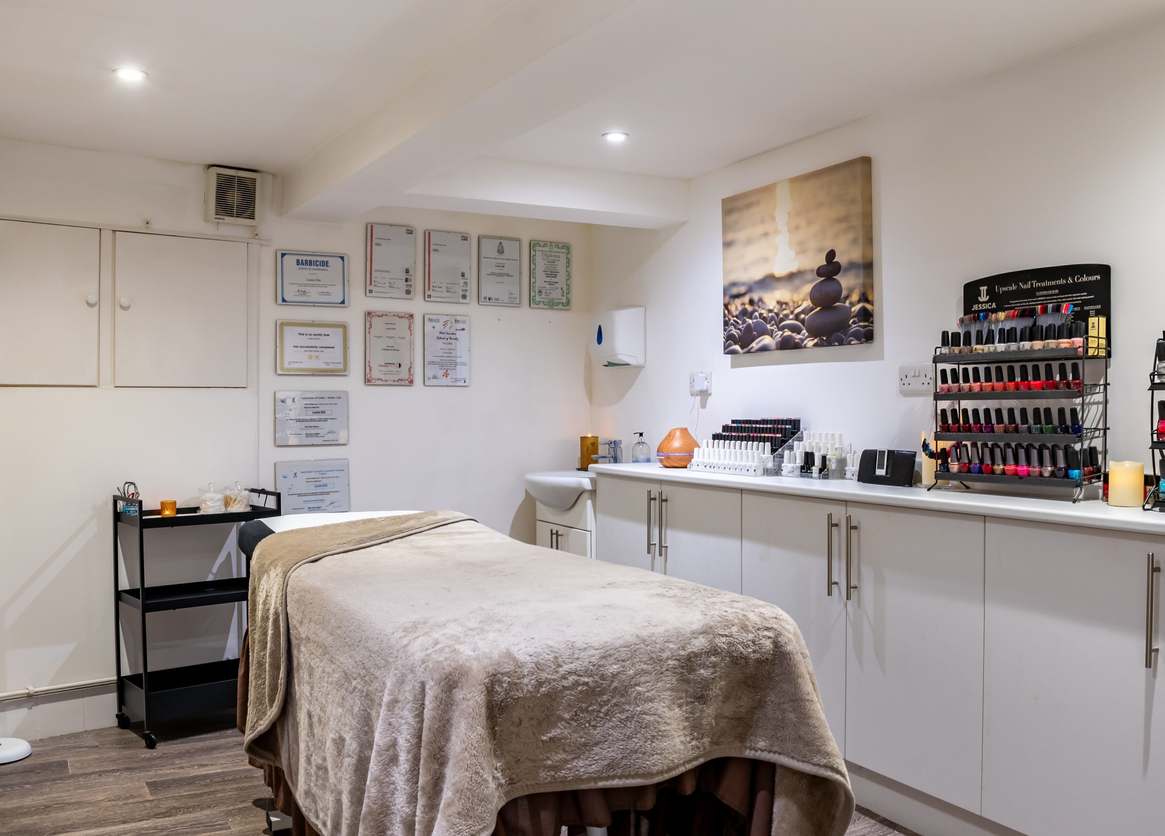 Peaceful treatment room at Design A Head Sevenoaks, Sevenoaks, England, GB, featuring cozy decor and nail polish display.