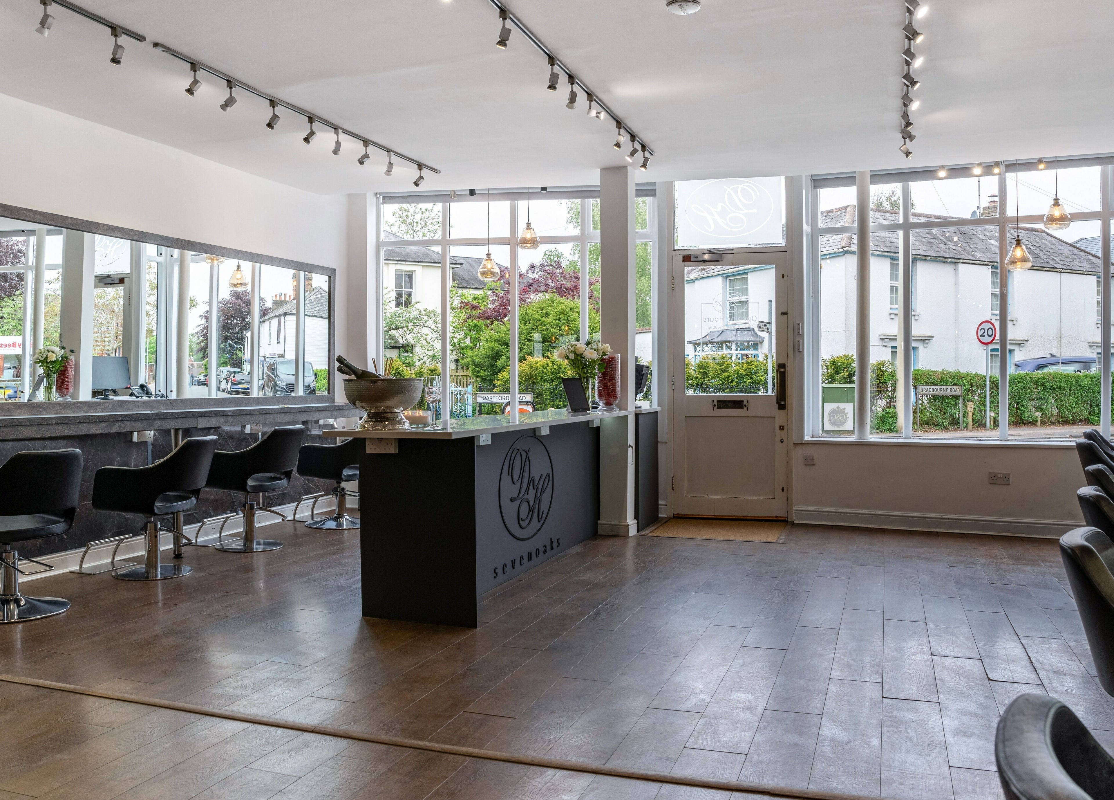 Modern salon interior at Design A Head Sevenoaks, Sevenoaks, England, GB. Bright space with styling chairs.