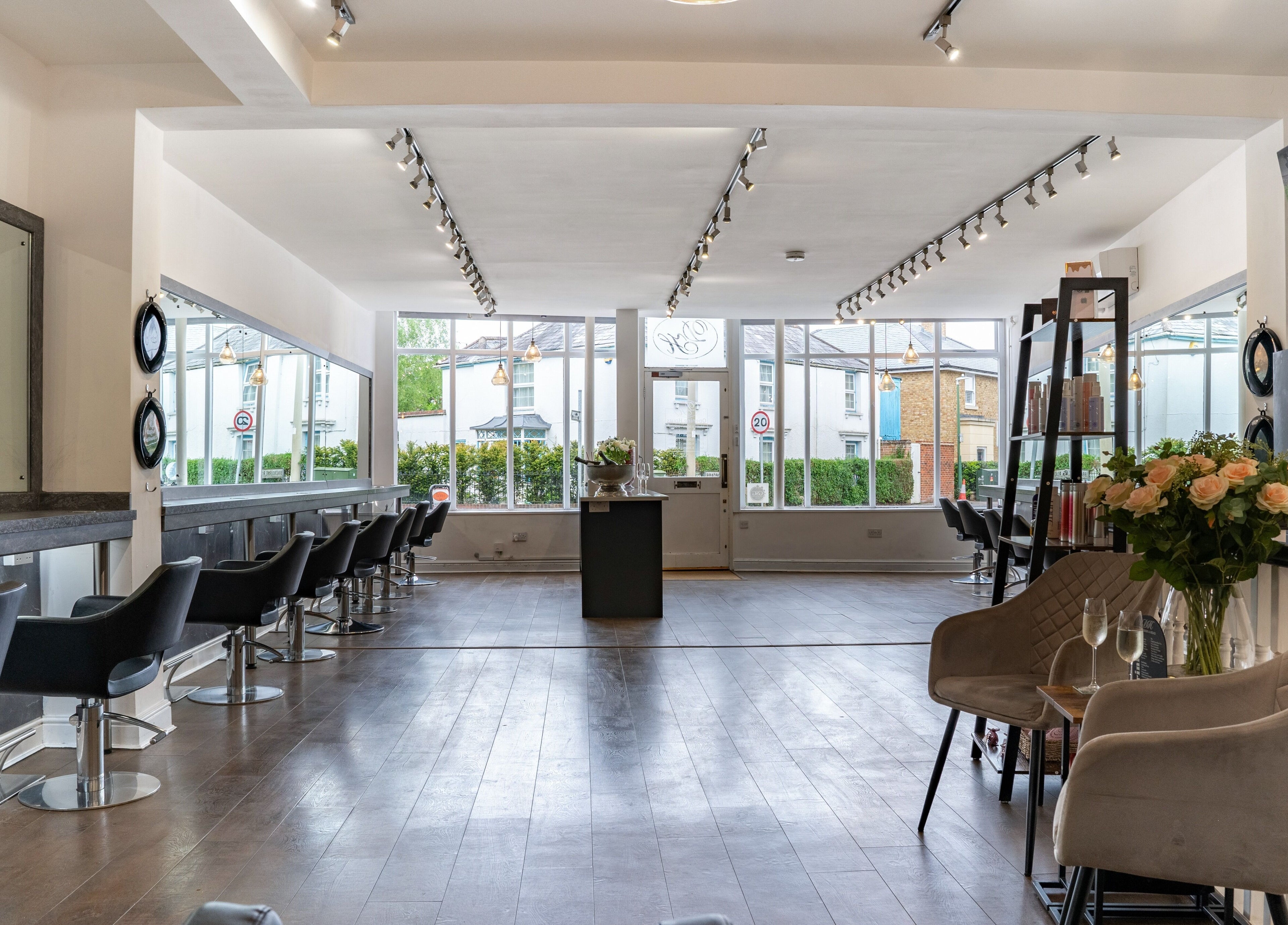 Spacious, modern interior of Design A Head Sevenoaks salon in Sevenoaks, England, GB with sleek black chairs.
