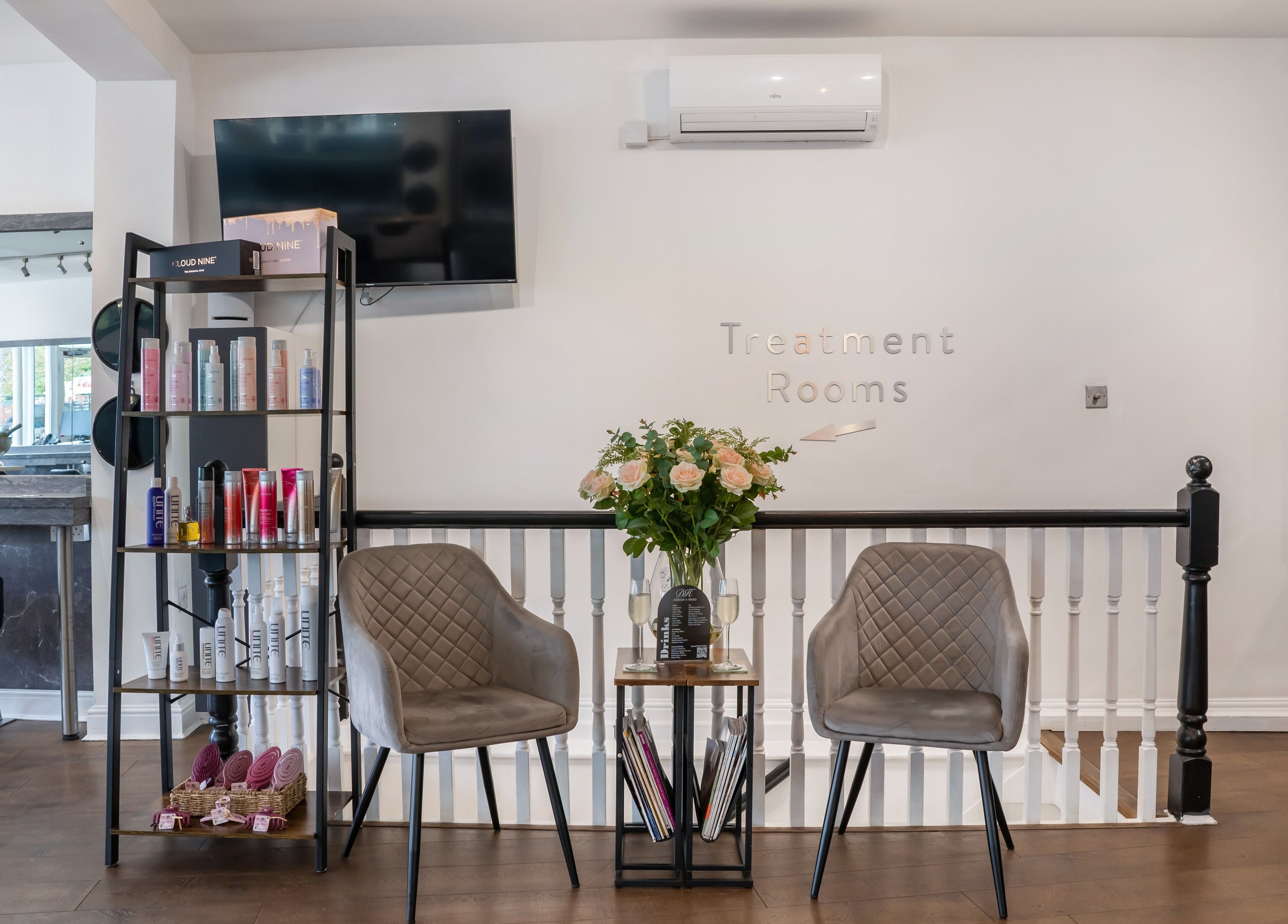 Chic reception area at Design A Head Sevenoaks, Sevenoaks, England, GB with seating and product display.