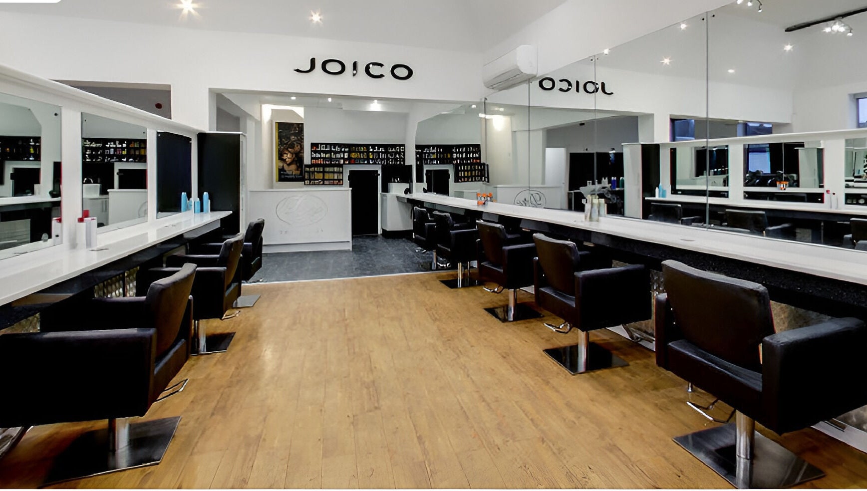 Elegant salon interior at Design A Head Tonbridge, Tonbridge, England, GB, featuring modern styling chairs and mirrors.
