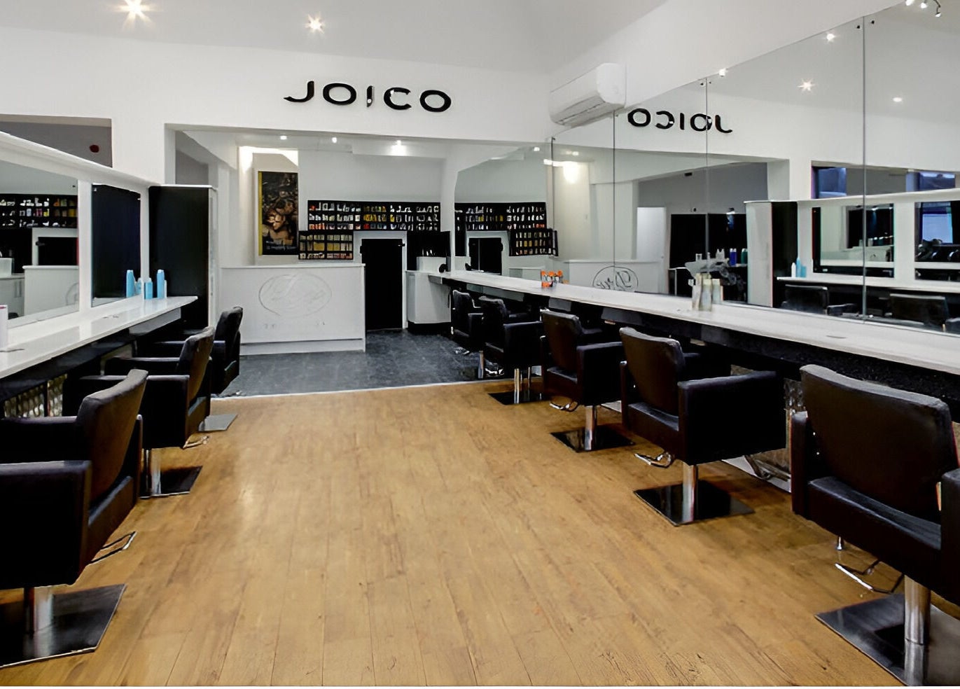 Elegant salon interior at Design A Head Tonbridge, Tonbridge, England, GB, featuring modern styling chairs and mirrors.