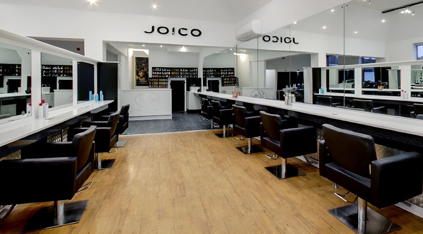 Elegant salon interior at Design A Head Tonbridge, Tonbridge, England, GB, featuring modern styling chairs and mirrors.